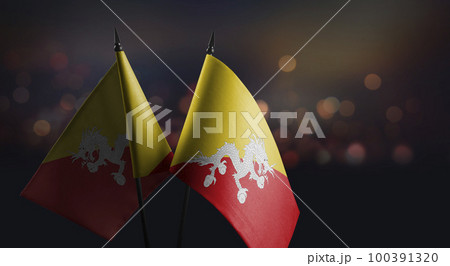 Small flags of the Bhutan on an abstract blurry background 100391320