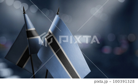 Small flags of the Botswana on an abstract blurry background 100391328