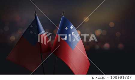 Small flags of the Samoa on an abstract blurry background 100391737