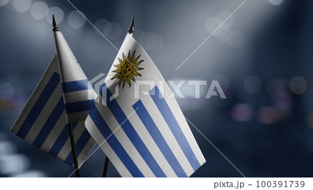 Small flags of the Uruguay on an abstract blurry background 100391739
