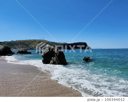 Rocky beach and crystal turquoise water of Ionian Sea in Albania. 100394032