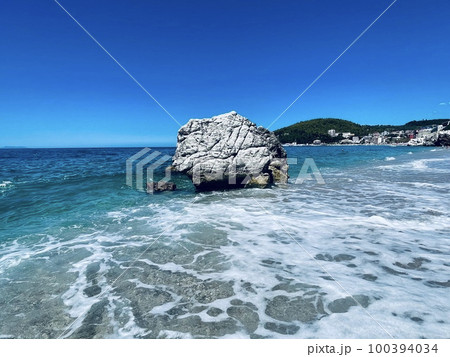 Rocky beach and crystal turquoise water of Ionian Sea in Albania. 100394034