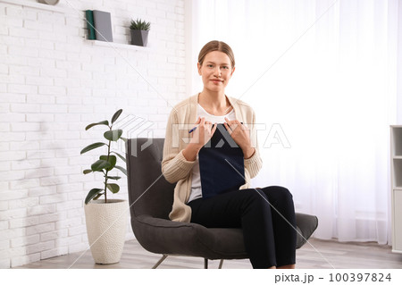 Professional psychotherapist with clipboard in modern office Professional psychotherapist with clipboard in modern office 100397824
