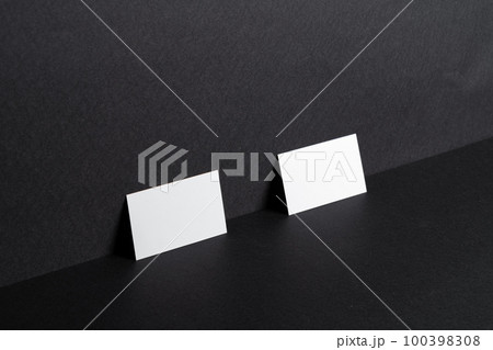 White businesscards on black background close up White businesscards on black background close up 100398308
