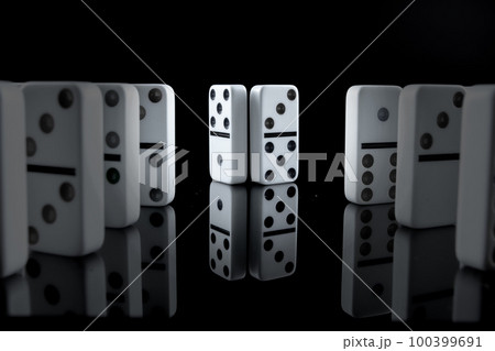White dominoes in the dark close up 100399691