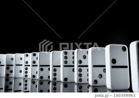 White dominoes in the dark close up 100399961