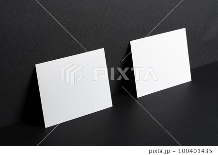 White businesscards on black background close up White businesscards on black background close up 100401435