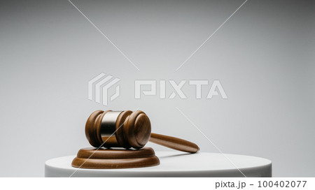 Brown wooden judge gavel on gray background 100402077
