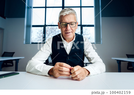 Mature businessman working at the desk in office. Mature businessman working at the desk in office. 100402159