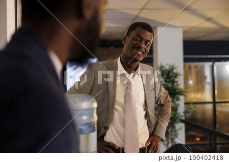 African american businessmen having fun during break time in startup office, relaxing before start working at company investment startegy. Coworkers brainstorming business ideas. Friendship concept African american businessmen having fun during break time in startup office, relaxing before start working at company investment startegy. Coworkers brainstorming business ideas. Friendship concept 100402418