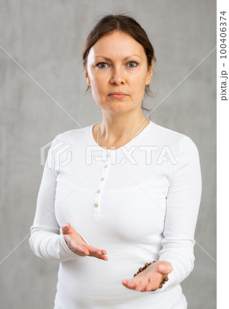 Portrait of displeased adult woman posing in studio Portrait of displeased adult woman posing in studio 100406374