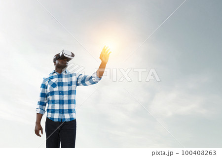 Man wearing virtual reality goggles Man wearing virtual reality goggles 100408263