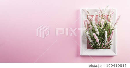 Happy Women's Day decoration concept made from flower and picture frame on pink pastel background. Happy Women's Day decoration concept made from flower and picture frame on pink pastel background. 100410015