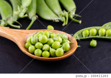 Sugar snap peas with mint on a rustic wood background Sugar snap peas with mint on a rustic wood background 100411263