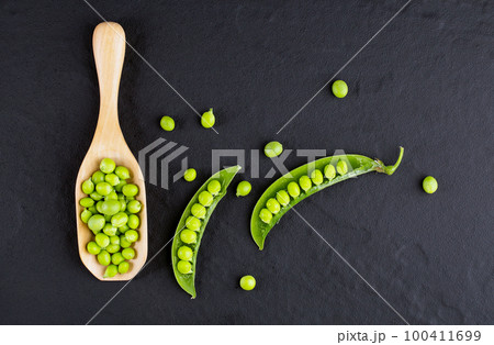 Sugar snap peas with mint on a rustic wood background Sugar snap peas with mint on a rustic wood background 100411699