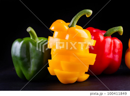 Three sweet peppers on a wooden background, Three sweet peppers on a wooden background, 100411849