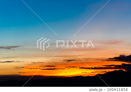 colorful dramatic sky with cloud at sunset. 100411858