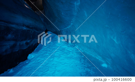 A huge corridor inside an ice cave in mountains 100416600