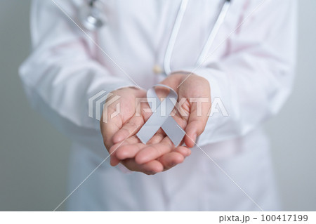 Brain Cancer Awareness May month, Doctor with grey color Ribbon for supporting life people. Healthcare and World cancer day concept Brain Cancer Awareness May month, Doctor with grey color Ribbon for supporting life people. Healthcare and World cancer day concept 100417199