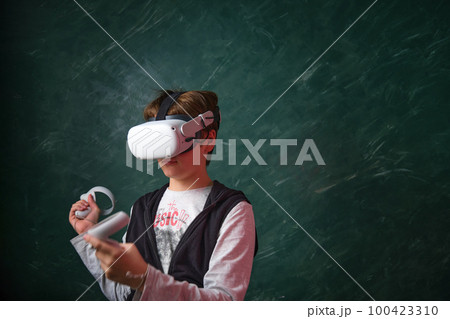 a boy playing with VR headset a boy playing with VR headset 100423310