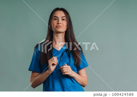 Portrait of young nurse with stethoscope, studio shoot. Portrait of young nurse with stethoscope, studio shoot. 100424589