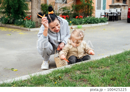 Grandparents in kids life, Grandparents teach children. Senior woman grandmother and little toddler girl playing outdoor. Playful activities with grandparents. 100425225