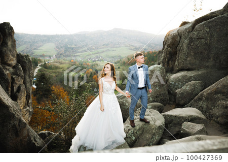 Loving husband and woman on the background of the mountains. Loving couple emotionally spends time 100427369