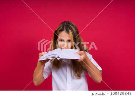 Child making notes. Kids dreams.Isolated on red background. Education, Kid back to school. 100429842