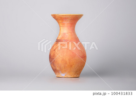 Used clay vase , pot on a gray background 100431833