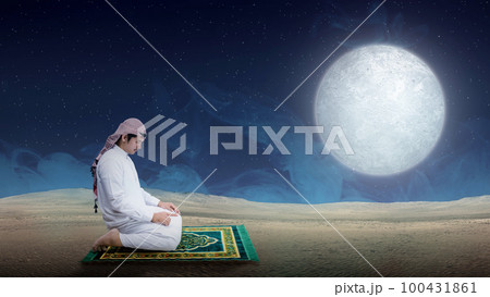 Muslim man with keffiyeh and agal in praying position (salat) on the prayer rug Muslim man with keffiyeh and agal in praying position (salat) on the prayer rug 100431861