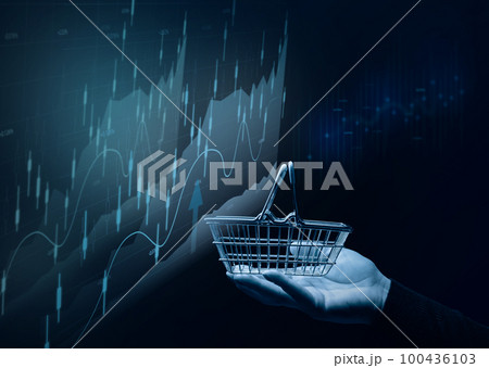 A female hand holding a miniature shopping basket and a chart with growing indicators, analysis of the market, high business profitability. 100436103