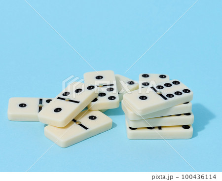 A stack of dominoes on a blue background, an intellectual game 100436114