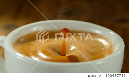 Macro Shot of Coffee Drop Falling into Fresh Espresso Cup 100437751