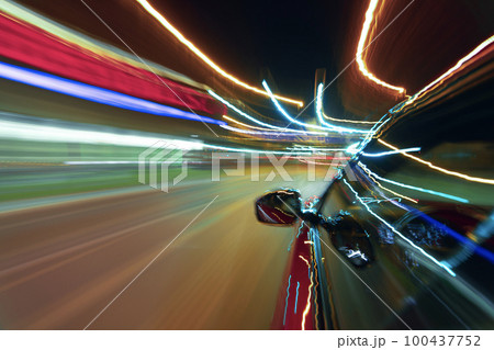 Long exposure of a speedy night drive in a big city 100437752