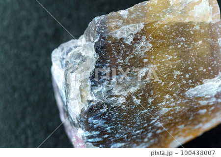 Raw fluorite mineral stone, natural minerals. Mineral fluorite translucent stone. Close up macro 100438007