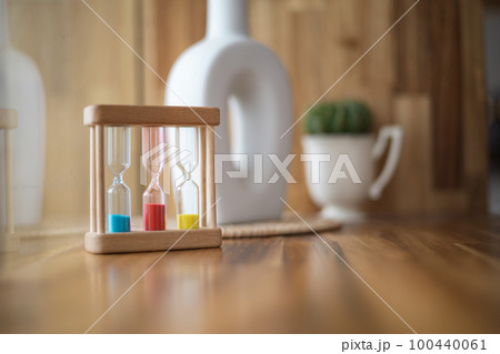 Colorful hourglasses with blurred background cute concept 100440061