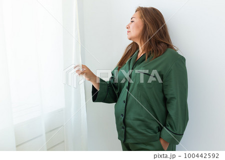 Fun minded woman wear pajama se rest relax spend time in living room lounge home in own room wake up copy space Fun minded woman wear pajama se rest relax spend time in living room lounge home in own room wake up copy space 100442592