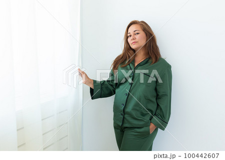 Fun minded woman wear pajama use rest relax spend time in living room lounge home in own room hotel wake up copy space Fun minded woman wear pajama use rest relax spend time in living room lounge home in own room hotel wake up copy space 100442607