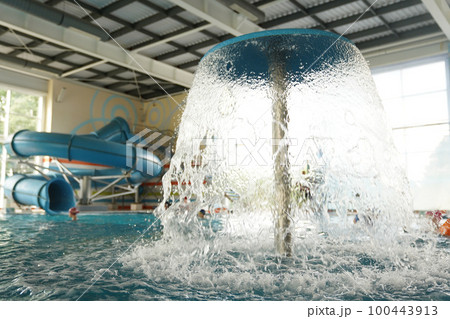 Close-up of the roof of a decorative mushroom with a waterfall of clear water on the background of a plastic slide in a water park. With space to copy. High quality photo Close-up of the roof of a decorative mushroom with a waterfall of clear water on the background of a plastic slide in a water park. With space to copy. High quality photo 100443913