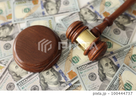 Judge gavel on dollar banknotes background. 100444737