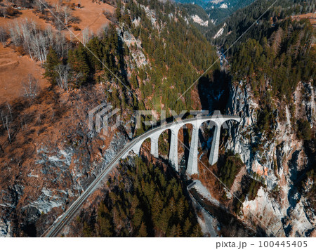 Aerial view famous mountain in Filisur, Switzerland. Landwasser Viaduct - world heritage with train Glacier express in Swiss Alps. Aerial view famous mountain in Filisur, Switzerland. Landwasser Viaduct - world heritage with train Glacier express in Swiss Alps. 100445405