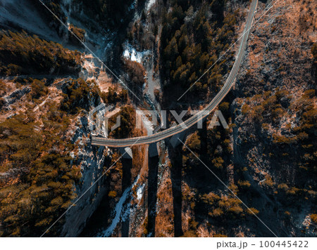 Aerial view famous mountain in Filisur, Switzerland. Landwasser Viaduct - world heritage with train Glacier express in Swiss Alps. 100445422