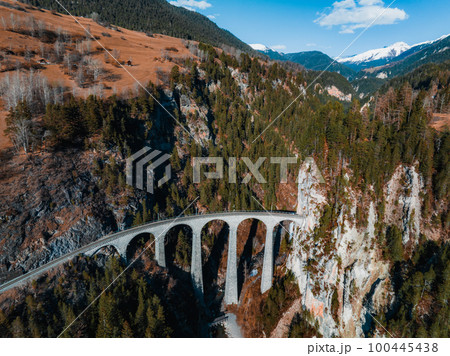 Aerial view famous mountain in Filisur, Switzerland. Landwasser Viaduct - world heritage with train Glacier express in Swiss Alps. Aerial view famous mountain in Filisur, Switzerland. Landwasser Viaduct - world heritage with train Glacier express in Swiss Alps. 100445438