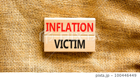 Inflation victim symbol. Concept words Inflation victim on wooden block. Beautiful canvas table canvas background. Business inflation victim concept. Copy space. 100446449
