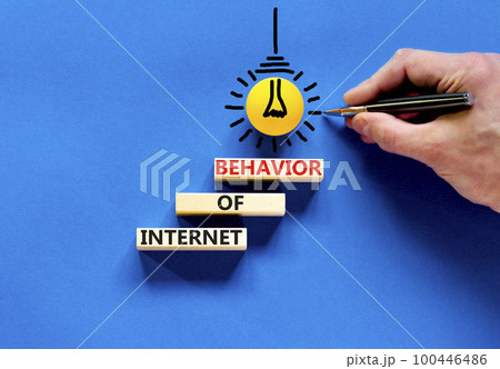 Internet of behavior symbol. Concept words Internet of behavior on wooden block on a beautiful blue table blue background. Businessman hand. Business Internet of behavior concept. Copy space. 100446486