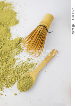 matcha green detox tea scattered with dry wooden spoon and bamboo whisk matcha green detox tea scattered with dry wooden spoon and bamboo whisk 100447456