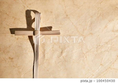 Palm sunday background. Cross from palm leaves on vintage background. Palm sunday background. Cross from palm leaves on vintage background. 100450430
