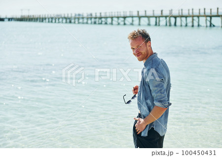 Clear water. Young european man have vacation and enjoying free time on the beach of sea Clear water. Young european man have vacation and enjoying free time on the beach of sea 100450431