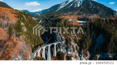 Aerial view famous mountain in Filisur, Switzerland. Landwasser Viaduct - world heritage with train Glacier express in Swiss Alps. 100450522