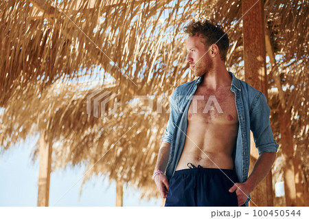 Young european man have vacation and enjoying free time on the beach of sea 100450544